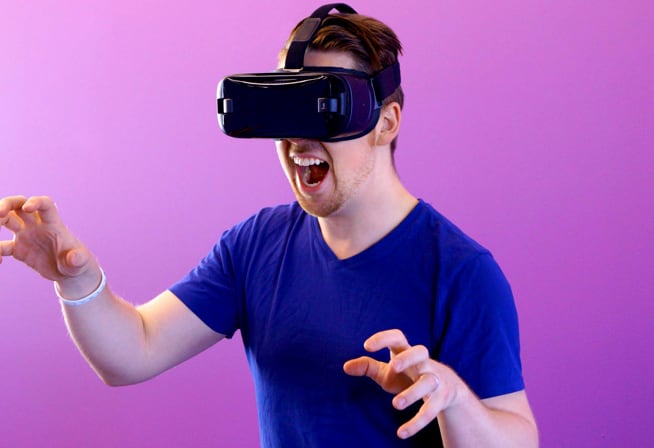 Excited man with a VR headset on his eyes